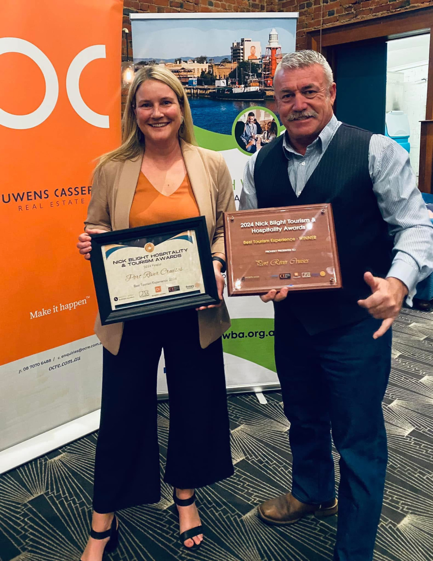 Tony and Sandy from Port River Cruises holding tourism awards